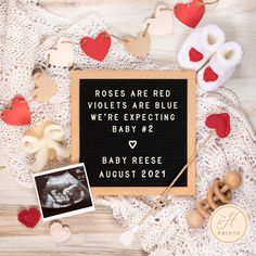 a sign that says roses are red violets are blue we're expecting baby 2