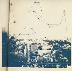 an open book with lines and dots on the cover, in front of a cityscape