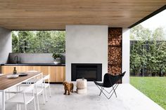 a dog is standing in the middle of an outdoor living area with fireplace and television