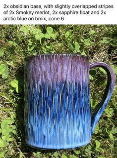 a blue and purple mug sitting in the grass