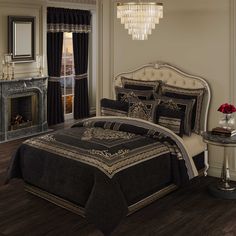 a bed room with a neatly made bed and a chandelier