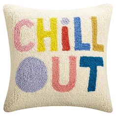 a pillow with the words chill out written in multicolored letters on white background