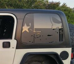 a white jeep with stars on the side window