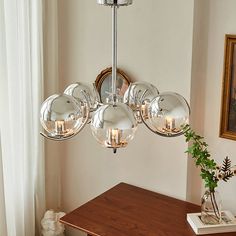 a chandelier hanging over a wooden table