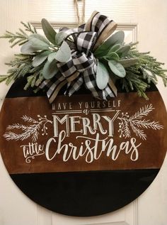 a wooden sign that says have yourself merry at the christmas door hanger with greenery on it