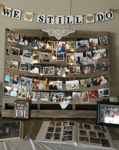 a table topped with pictures and photos next to a sign that says we still do