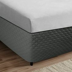 a close up view of a mattress on a wooden floor