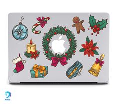 an apple laptop with christmas decorations on it