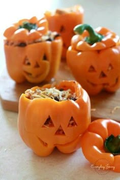 several carved pumpkins with faces on them