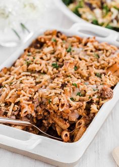 a casserole dish with meat and vegetables in it, ready to be eaten