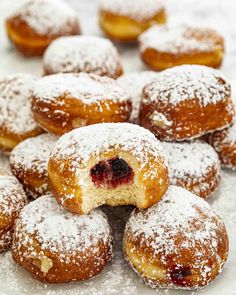 powdered sugar covered donuts with blueberries in the middle