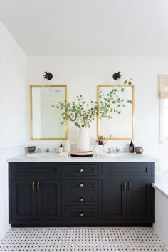 a bathroom with two sinks and mirrors on the wall