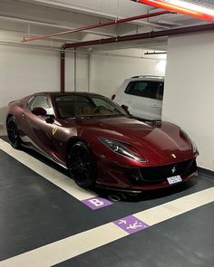 a red sports car parked in a parking garage