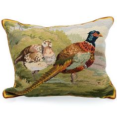 a decorative pillow with two birds on it