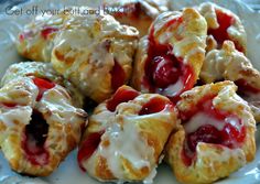 croissants with cream cheese and cherry filling on a white plate