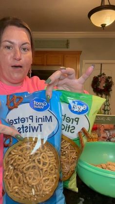 a woman holding two bags of mini pretzel twists