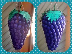 two pictures of grapes hanging from hooks on the wall, one with green and blue leaves