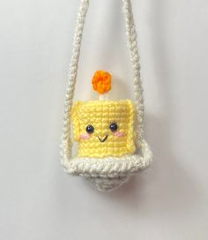 a crocheted bag with a yellow piece of cake on it