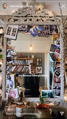 a person taking a selfie in front of a mirror with many pictures on it