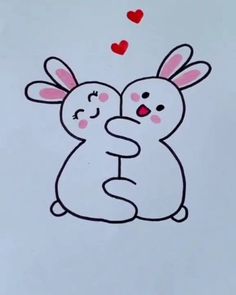 two rabbits hugging each other with hearts flying in the air behind them on a sheet of paper