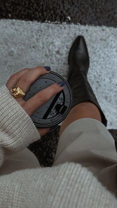 a woman's legs with black and gold rings