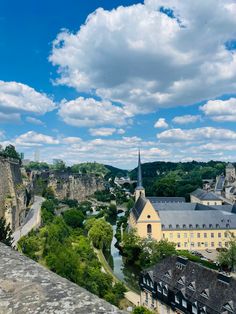 the city is surrounded by old buildings and green trees, with blue skies in the background