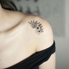 a woman with a flower tattoo on her shoulder