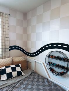 a bed room with a neatly made bed and checkered walls