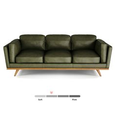 a green leather couch sitting on top of a white floor next to a wooden frame