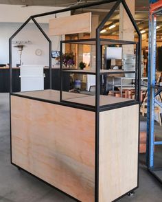 an office building with wooden walls and black trim on the front, and windows in the back