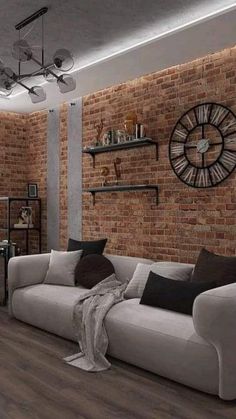 a living room filled with furniture and a large clock mounted to the side of a brick wall