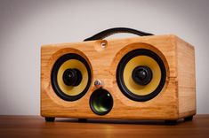 a wooden speaker sitting on top of a table