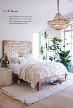 a bedroom with a bed, rug and plants on the floor in front of a window