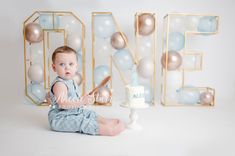 a baby sitting in front of a cake