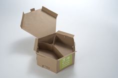 an open cardboard box sitting on top of a white table