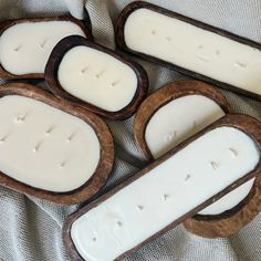 four wooden slices with white wax on them