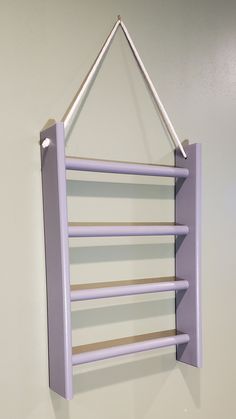 a purple shelf hanging from the side of a wall