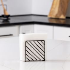 a square object sitting on top of a white counter