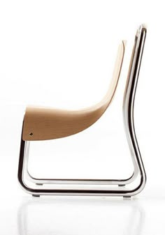 a modern chair with a wooden seat and metal frame, on a white surface in front of a plain background