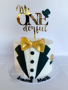 a cake decorated with a tuxedo and the words onederful on it