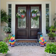 the front door is decorated with fake flowers and wreaths