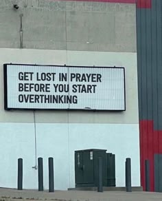 a sign on the side of a building that says get lost in prayer before you start overthiking