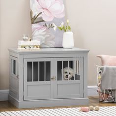 a small white dog in a grey cabinet