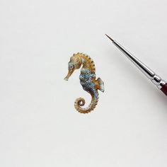 a painting of a sea horse next to a paintbrush