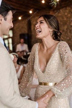 the bride and groom are laughing at each other