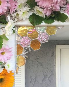 a mirror that has some flowers on it next to a wall with pink and white flowers