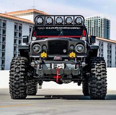 an off - road vehicle is parked in front of a building