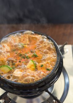 a bowl of soup is sitting on a plate