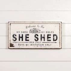 a sign on the side of a building that says she shed