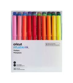 the bright colored cricut pens are lined up in a display box on a white background